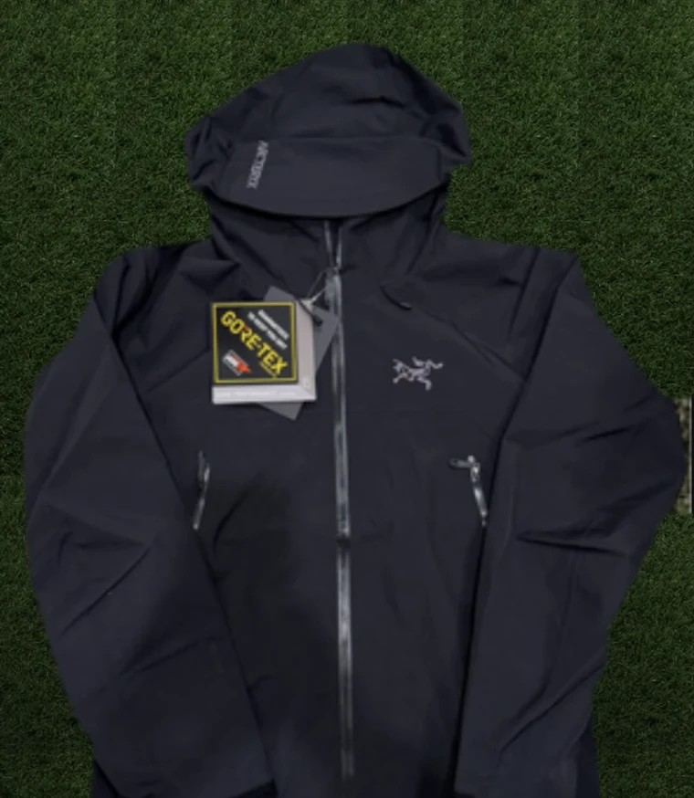 Black Arc’teryx shell jacket on turf